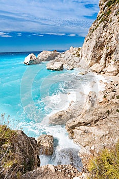 Lefkada Island cliffs with rough sea and clear bluew waves photo