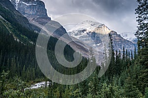 Lefroy Peak in Canadian Rockies lit by a sunlight on otherwise cloudy day. Mt.Lefroy viewed from the Plain of Six Glaciers trail,