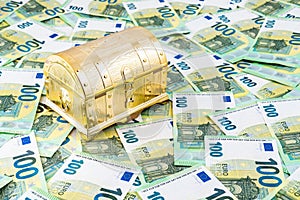 Left angle view on closed golden chest on euro money bills, Pandora chest concept of financial hazards