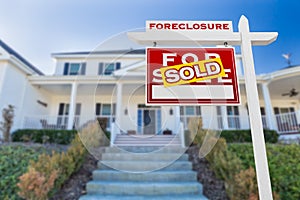 Left Facing Foreclosure Sold For Sale Real Estate Sign in Front of Home