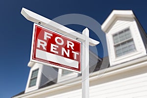 Left Facing For Rent Real Estate Sign In Front of House and Deep