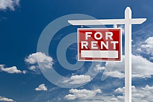 Left Facing For Rent Real Estate Sign Over Blue Sky and Clouds W