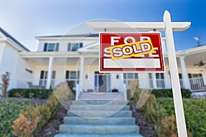 Left Facing Sold For Sale Real Estate Sign In Front of House.