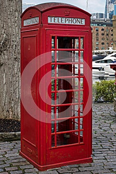 Traditional red english phone booth facing right