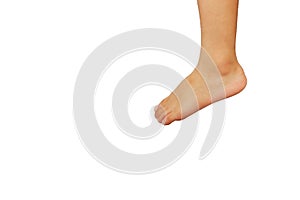 The left foot and left leg of an Asian boy are shown stepping on something. on a white background