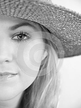 Left half of face of handsome, young woman in black and white shot