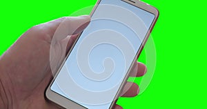 Left hand of Caucasian man holds generic phone with white display, on green screen background.