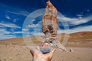 Left hand holding crystal ball in Atacama Pacana Monks