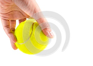 Left hand holding new yellow tennis ball on white background, ready to serve position