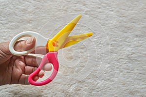 Left hand with zigzag scissors for craft work