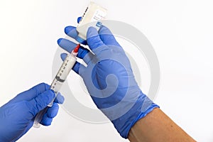 Left Handed Anesthesiologist Withdrawing Propofol into a Syringe photo