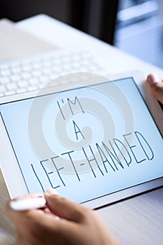 Left-handed man writing text I am a left-handed