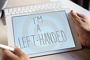 Left-handed man writing text I am a left-handed photo
