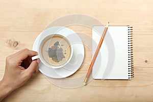 A left-hander holds a cup