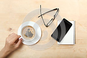 A left-hander holds a cup