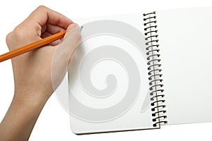 Left-hander writes in a notebook