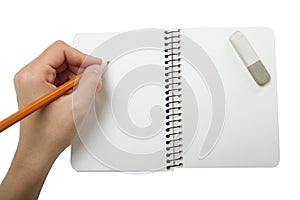 Left-hander writes in a notebook