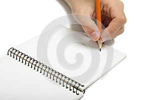 Left-hander writes in a notebook