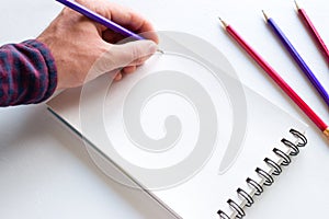 The left-hander writes in a notebook mockup photo