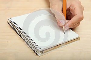 The left-hander writes in a notebook