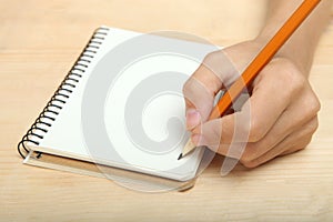 The left-hander writes in a notebook