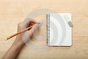 The left-hander writes in a notebook