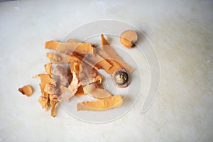 Left over peels of a carrot on a white chopping board in an Indian kitchen