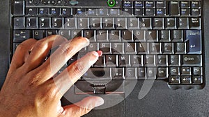 left palm on laptop keypad, ready to type