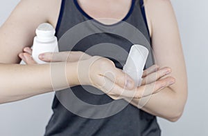 left or right. Girl chooses between eco-friendly deodorant without toxins and antiperspirant with toxic elements. In left hand photo