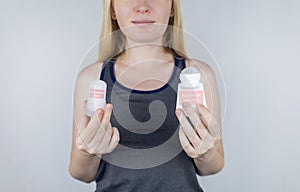 left or right. Girl chooses between eco-friendly deodorant without toxins and antiperspirant with toxic elements. In left hand photo