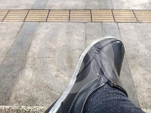 Left side Men's shoes and socks on a blurred floor background