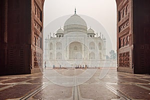 Left side of the Taj Mahal in Agra, India, on overcast morning with smog