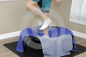 Left Side View of Male Legs Jogging on a Round Rebounder Closeup