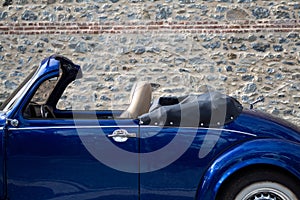 Left side view of navy blue classic convertible car