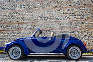 Left side view of navy blue classic convertible car