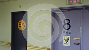 Left to right pan video of an empty corridor of a Japanese hospital of Tokyo in the IRM radiology department doors