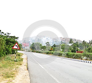 Left turn sign board on a highway at a left curve on road