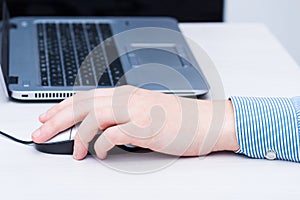 Lefthander using computer mouse with left hand. Left handed day concept