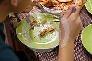 Leftovers from fried chicken legs on a plate