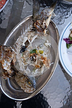 Leftovers of sea bream seafood on a plate