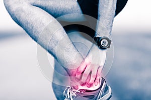 Leg ankle pain, man holding sore and painful foot photo