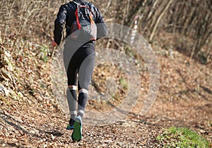 Leg of athlete runner from behind during racing on the trail