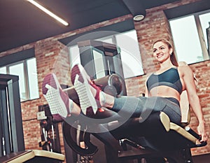 Leg extension exercise workout smilling sporty woman