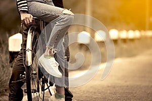 Leg and feet of young couple riding a bicycle togetherp