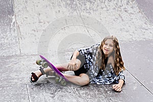 Leg and knee injury on penny board. Child traumatology. Child girl falling from skate board and get injured and feeling