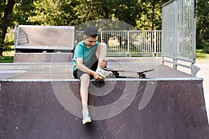 Leg and knee injury on skate board. Child traumatology. Child boy falling from skate board and get injured and feeling