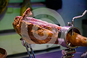 Leg of pork serrano Iberian cured jamon on stand in Spanish butcher\'s shop