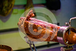 Leg of pork serrano Iberian cured jamon on stand in Spanish butcher\'s shop