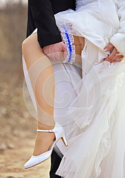 Leg and shoes of wedding couple