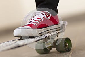 Leg on skateboard on street